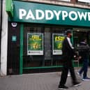 A person walking past a PaddyPower store
