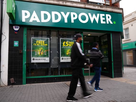 A person walking past a PaddyPower store