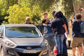 Sharif Ahmadzai is escorted into a car