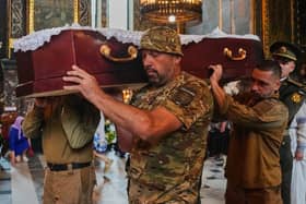 Soldiers carry a coffin