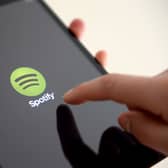 A person with the Spotify app on an iPad