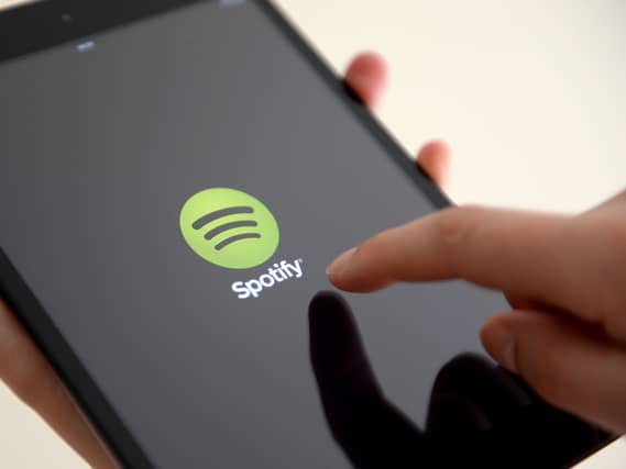 A person with the Spotify app on an iPad