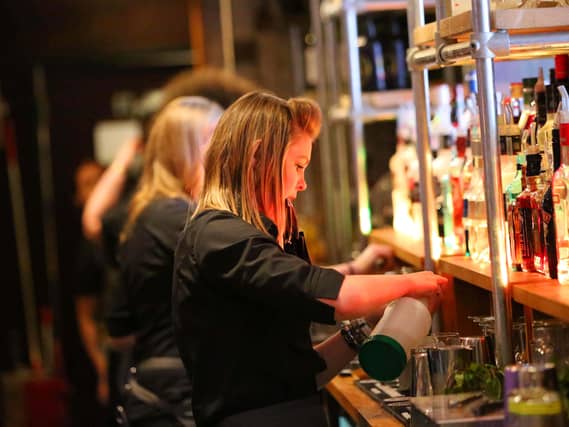 Bar staff serving customers