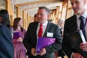 Joe Fagan walking through a corridor at Holyrood