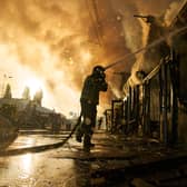 Firefighters try to put out a fire after a Russian missile attack in Kyiv