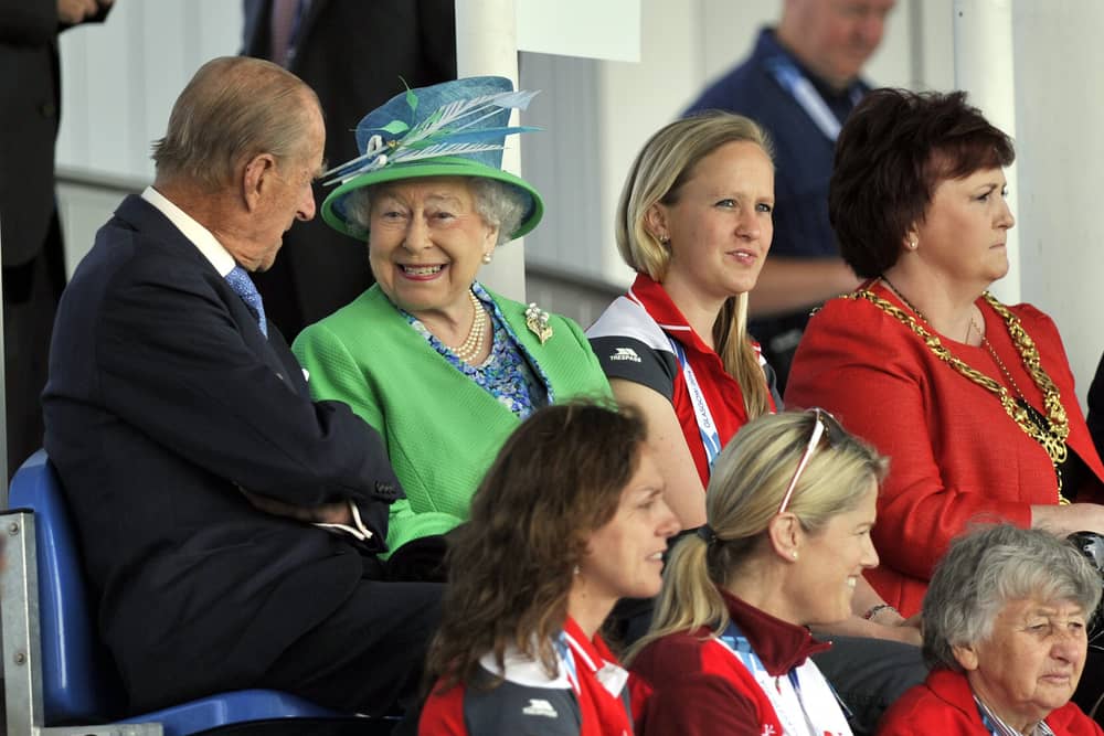 Queen Elizabeth II and the Duke of Edinburgh sit in the stands to watch the England v Wales match at the National Hockey Centre during the 2014 Commonwealth Games in Glasgow. P