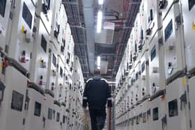 A man walking through a large data centre