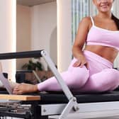 Woman and pilates instructor on reformers in studio, closeup