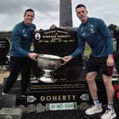 Pictured are Stephen Coen and Diarmuid O'Connor with the Sam Maguire Cup at the grave of their former teammate Darragh Doherty from Kilmaine.