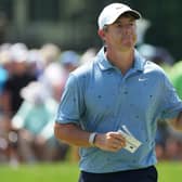 Rory McIlroy waves to the crowd on the 18th green
