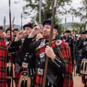 Lonach Highlanders stop for a dram of whisky during their march