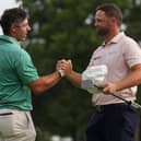 Rory McIlroy, of Northern Ireland, speaks with Wyndham Clark as Clark wins the final round of the BMW Championship