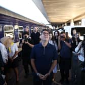 Andy Burnham at a train station in Kyiv, surrounded by photographers
