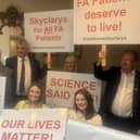 People with posters campaigning about the drug Skyclarys
