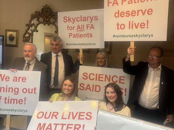 People with posters campaigning about the drug Skyclarys