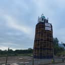A bonfire pyre with a replica mosque on the top