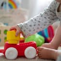 An infant playing with toys