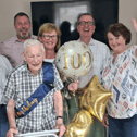 Bob Savage with his family at his 100th birthday celebration. From left, his son Andrew, Doug Drummond, Tanya Barry, his son Christopher, Ute Doerge-Baischew and Melanie Griffith