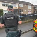 A police officer and car outside a house in Dungannon