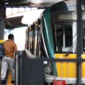 A person walking by a train