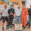   Daniel Ormond (in black, second from left) with ​John Quill, Irish Forest Rally Championship Manager; Sean Daly, Cork Motor Club; Mairead Duane, and Leonard Downey at the finish of the recent Jim Walsh Cork Forest Rally.  
