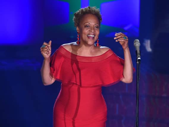 Cassandra Wilson singing in a red dress