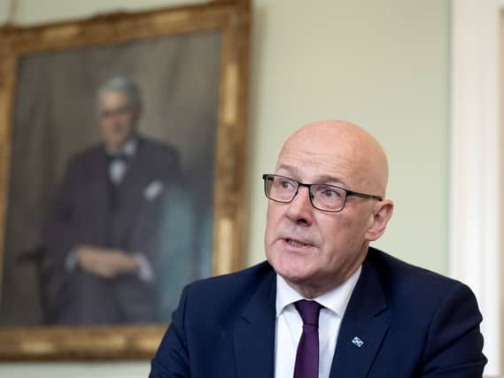 John Swinney speaks to journalists