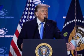 Donald Trump speaking at a lectern