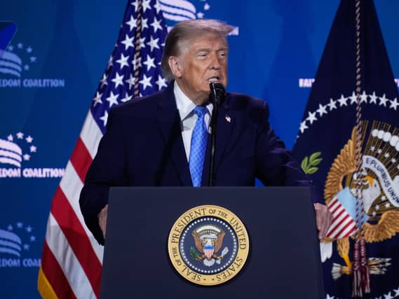 Donald Trump speaking at a lectern