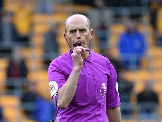 Mike Dean blows whistle