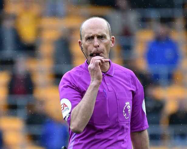 Mike Dean blows whistle