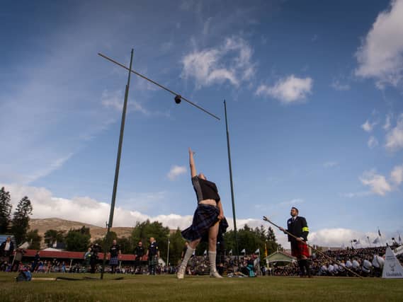 A person competes in weight tossing category during the Braemar Gathering highland games