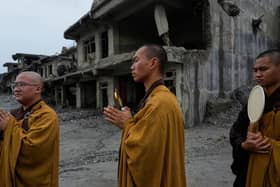 Buddhist monks offer prayers for the departed