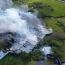 Smoke billowing from the Doagh Famine Village following a fire in May 2025.