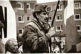 Ojibwe leader and founder of the American Indian Movement (AIM), Clyde 'The Thunder Before the Storm' Bellecourt, addressing the 1985 Bloody Sunday commemoration in the Bogside with Seán Keenan pictured in the background.