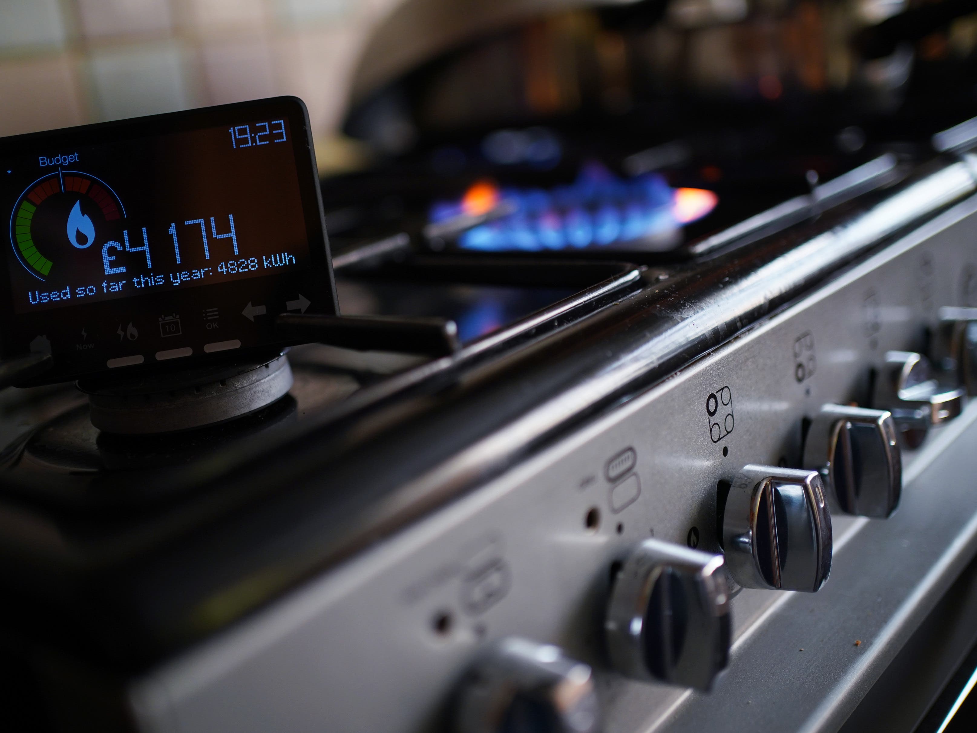 A handheld smart meter on a kitchen hob s