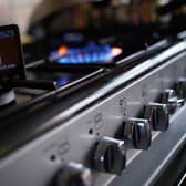 A handheld smart meter on a kitchen hob s