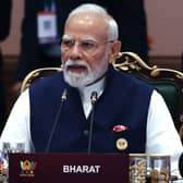Narendra Modi speaking while seated