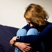 Woman sitting with head down