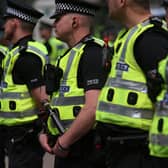 A line of Police Scotland officers in uniform