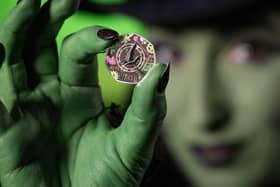 Wicked coin being held up
