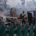 Firefighters put out a fire at private homes after a Russian air attack in Sumy, Ukraine