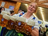 A barmaid with lots of lovely, foamy pints