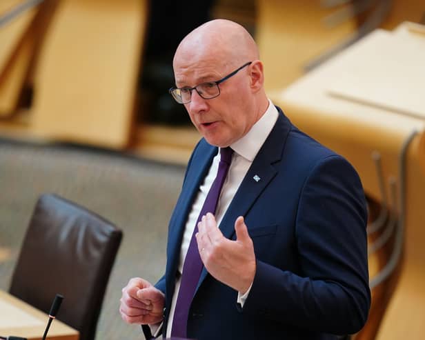 John Swinney standing while speaking in Holyrood