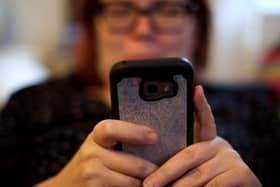 A woman looking at a mobile phone