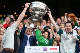 The late Seamus Tuohy is pictured with follow officers, Secretary Ronan Kirrane, Treasurer Valerie Murphy, and PRO Paul Cunnane lifting the Sam Maguire after Mayo’s All-Ireland victory on July 26. Seamus’s funeral will take place exactly two months after the victory, on September 26
