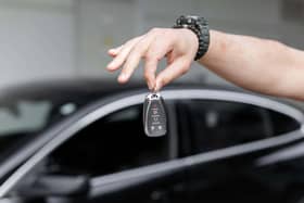 A man holding car keys