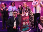 The Duchess of Edinburgh cutting the cake with Ellie Goldstein as she attends an event to celebrate 80 years of Mencap