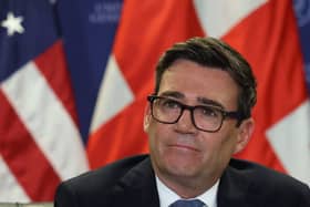 Andy Burnham in front of a stars and stripes and union flag