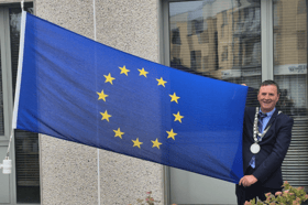 Mayor Liam Brazil poses with the EU flag to mark Ireland’s council presidency